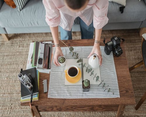 Person arranging their home office desk for better posture